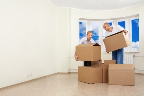 Professional movers loading furniture into a van in Shacklewell